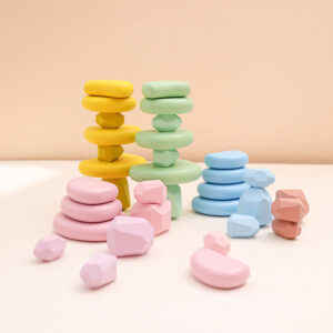 balance blocks stacker toy: wooden stone pebbles in candy colors for montessori baby games.